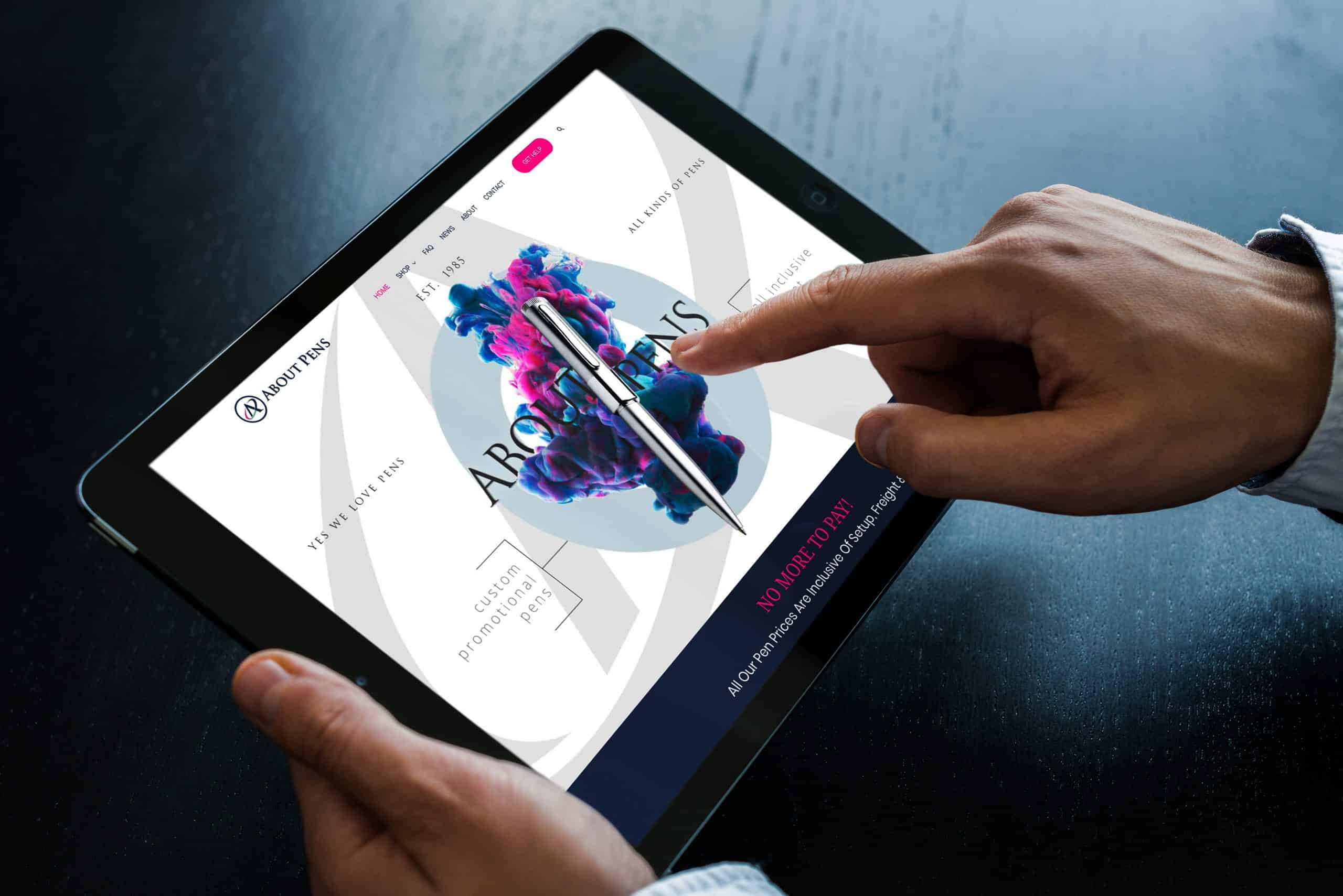 A person holding an ipad displaying a website design for a Home.