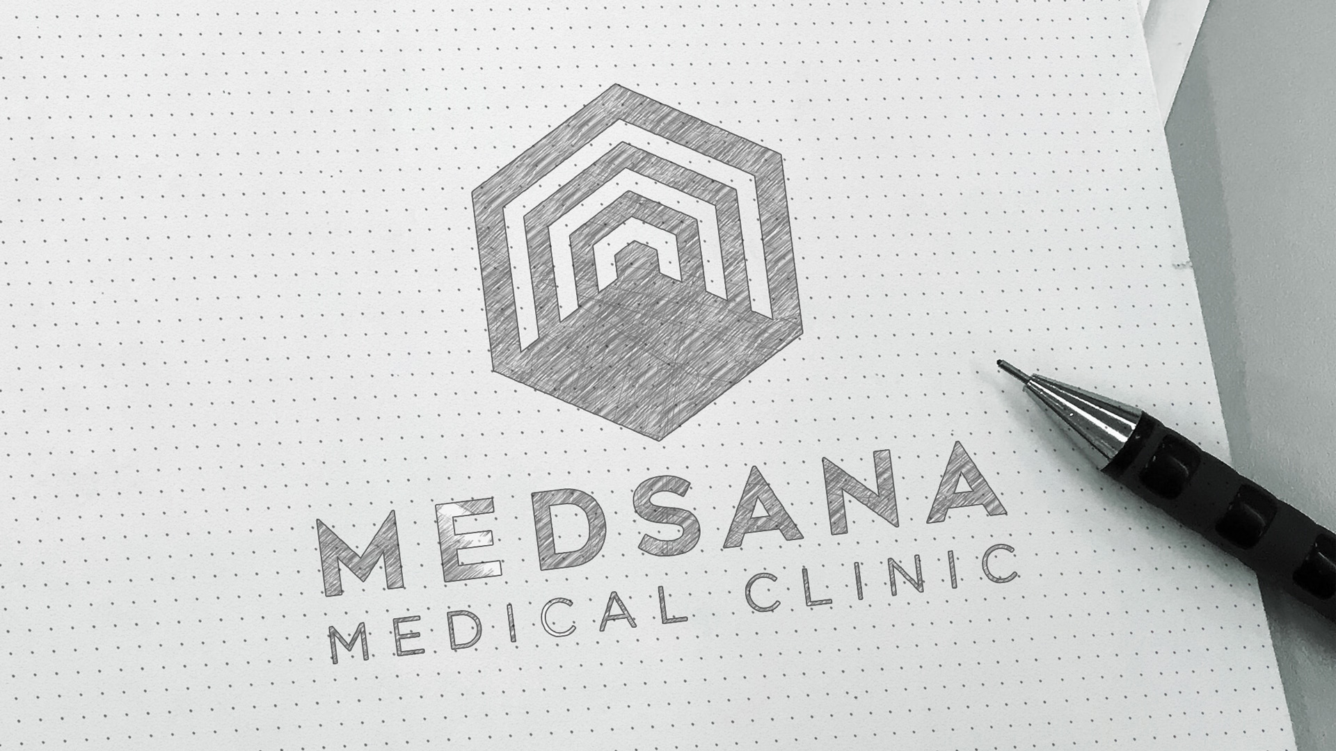 A hand-drawn Logo Design 2026 featuring hexagonal geometric shapes above the text "MEDSANA MEDICAL CLINIC" on dotted paper, with a black mechanical pencil beside it.